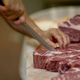 Person cutting raw meat